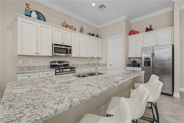 kitchen featuring crown molding, sink, white cabinets, and appliances with stainless steel finishes