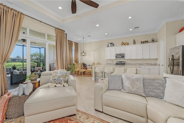 tiled living room featuring crown molding and ceiling fan