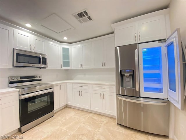 kitchen featuring stainless steel appliances and white cabinets