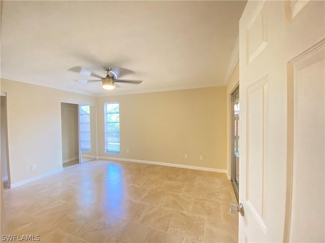 spare room with ornamental molding and ceiling fan