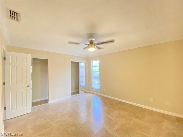 unfurnished room with ceiling fan