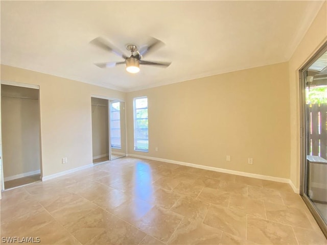 unfurnished room with ceiling fan and a wealth of natural light