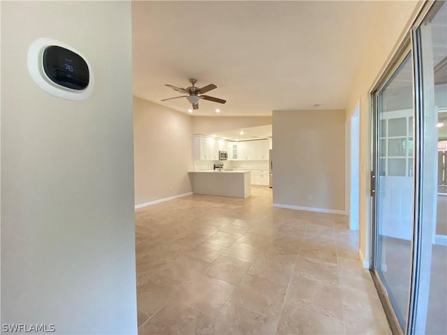 unfurnished living room featuring ceiling fan