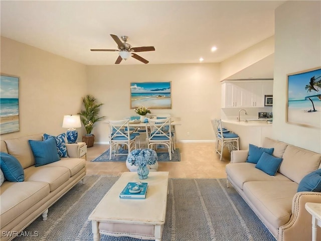 living room with ceiling fan and sink