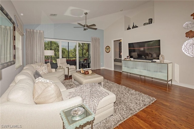 living room with ceiling fan, wood-type flooring, and vaulted ceiling