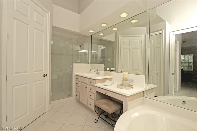 bathroom with tile patterned flooring, vanity, and independent shower and bath