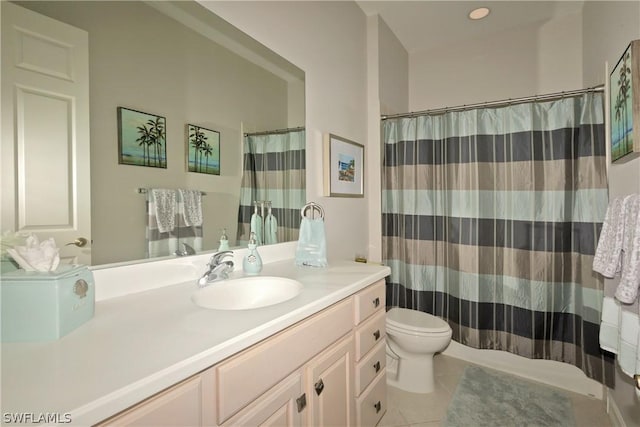 bathroom featuring tile patterned flooring, vanity, and toilet