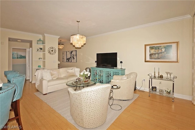 living room with hardwood / wood-style floors, crown molding, and a chandelier