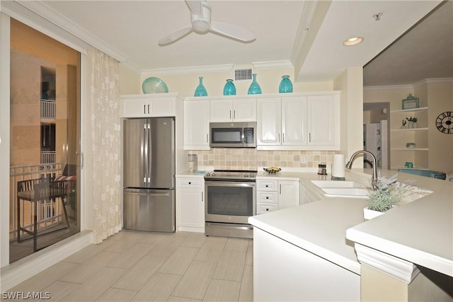 kitchen featuring appliances with stainless steel finishes, white cabinetry, and sink