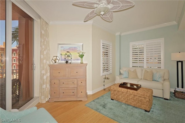 living room featuring crown molding, ceiling fan, and light hardwood / wood-style floors