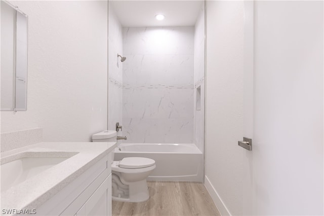 full bathroom with tiled shower / bath combo, vanity, toilet, and hardwood / wood-style floors