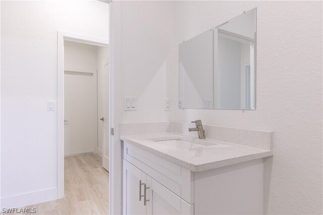 bathroom featuring hardwood / wood-style flooring and vanity