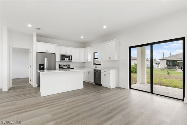 kitchen with appliances with stainless steel finishes, light wood-type flooring, and plenty of natural light