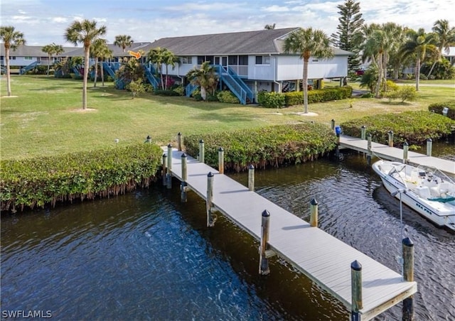 dock area with a water view and a yard