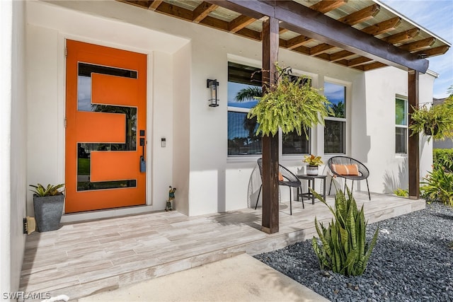 view of exterior entry with a porch