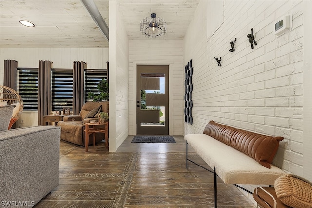 foyer entrance featuring dark hardwood / wood-style floors and a notable chandelier