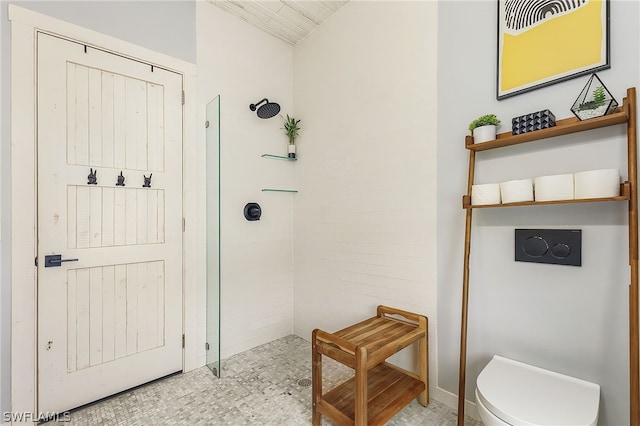 bathroom featuring a shower and toilet