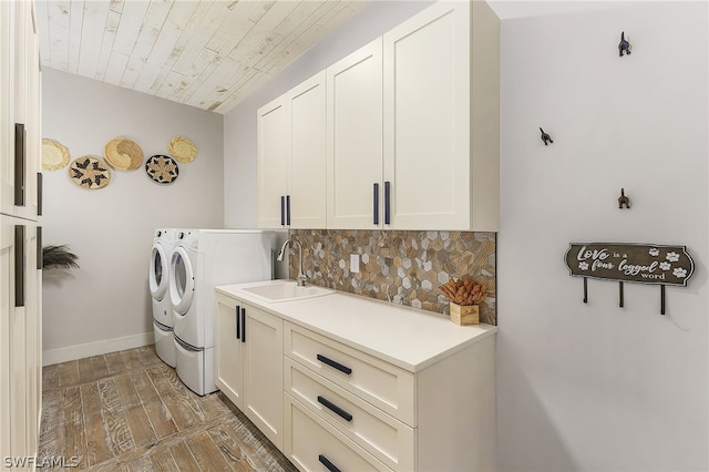 washroom with sink, wooden ceiling, cabinets, hardwood / wood-style floors, and washer and clothes dryer