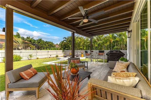 view of patio / terrace featuring an outdoor living space, area for grilling, and ceiling fan