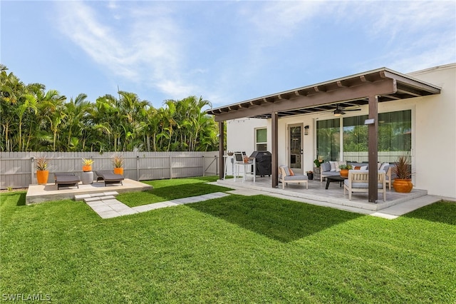 rear view of house with a lawn, ceiling fan, a patio, and an outdoor hangout area