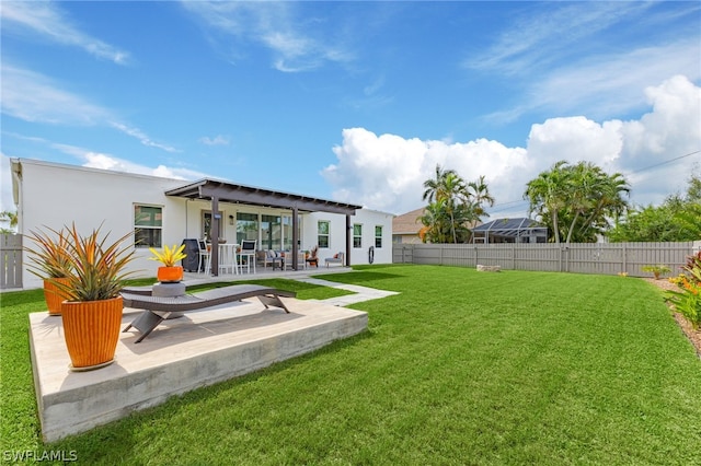 rear view of property featuring a patio and a lawn