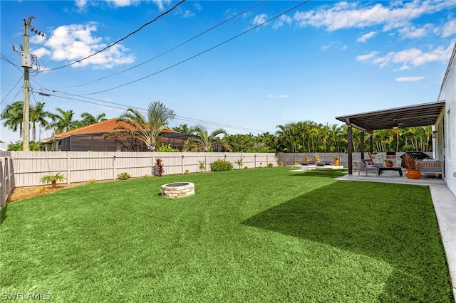 view of yard with an outdoor fire pit, a patio area, and ceiling fan