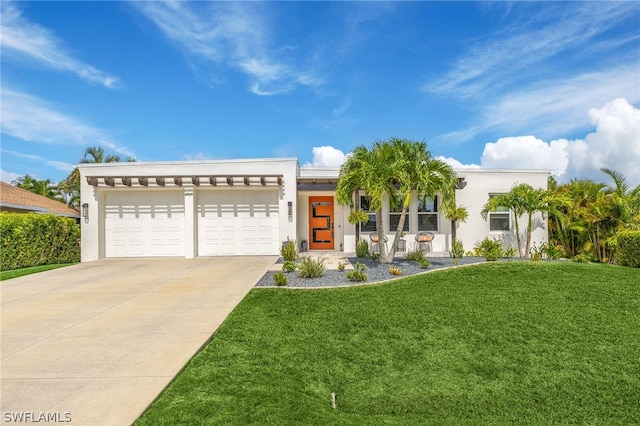 view of front of home with a garage and a front yard