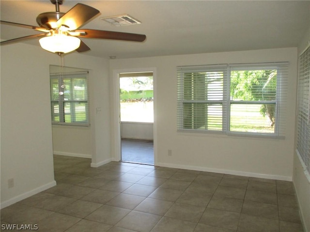 tiled empty room featuring ceiling fan