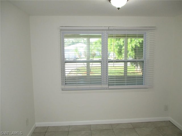 tiled spare room with a wealth of natural light