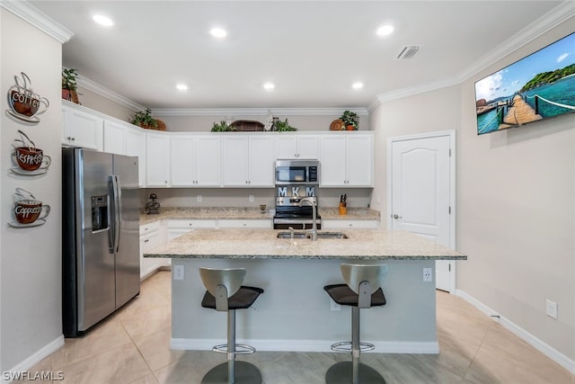 kitchen featuring stainless steel appliances, a kitchen island with sink, and white cabinets