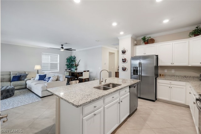 kitchen featuring appliances with stainless steel finishes, sink, white cabinets, a kitchen island with sink, and ceiling fan