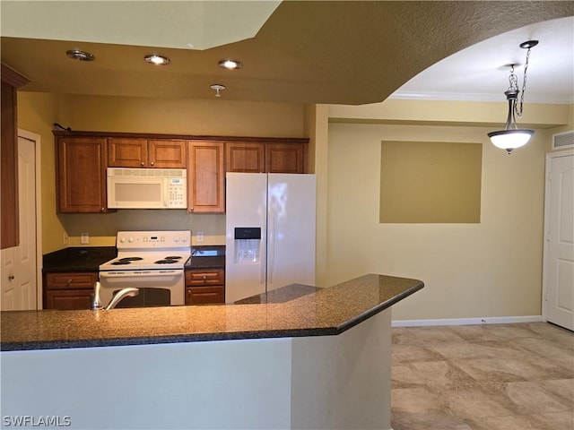 12940 Positano Cir Unit 201, Naples, FL 34105 - kitchen with white appliances, dark countertops, pendant lighting, crown molding, and brown cabinets