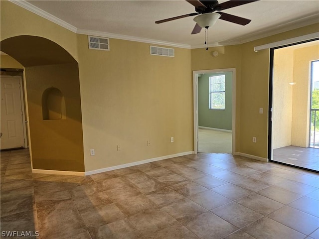 12940 Positano Cir Unit 201, Naples, FL 34105 - spare room featuring plenty of natural light, crown molding, arched walkways, a ceiling fan, and baseboards