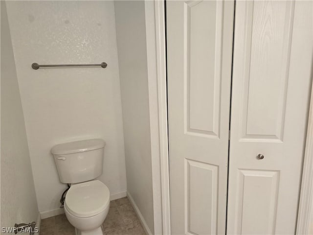 12940 Positano Cir Unit 201, Naples, FL 34105 - bathroom with baseboards, toilet, and tile patterned flooring