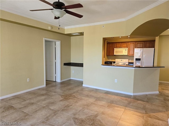 kitchen featuring dark countertops, crown molding, baseboards, white appliances, and a ceiling fan