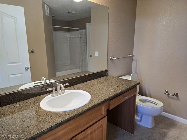 12940 Positano Cir Unit 201, Naples, FL 34105 - full bathroom featuring toilet, vanity, tile patterned floors, and baseboards