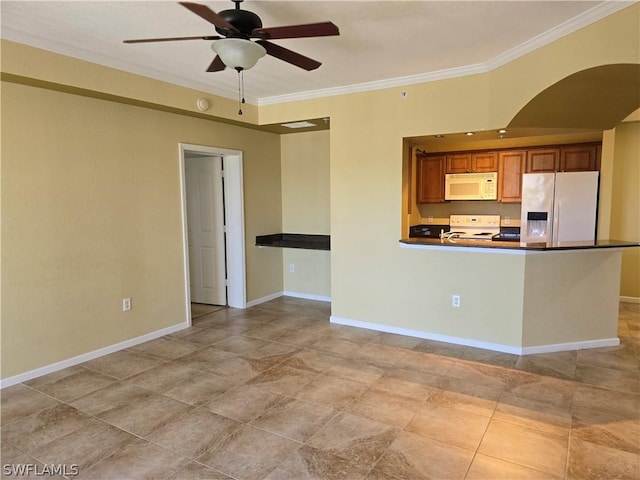 kitchen with dark countertops, white appliances, crown molding, and ceiling fan