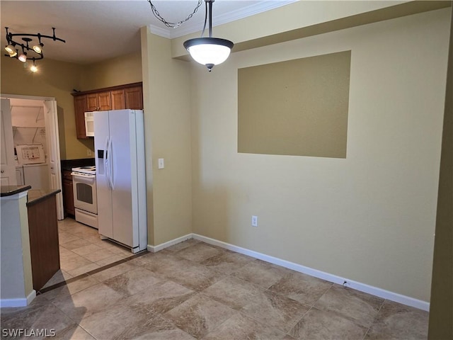 12940 Positano Cir Unit 201, Naples, FL 34105 - kitchen featuring white appliances, dark countertops, ornamental molding, brown cabinetry, and pendant lighting