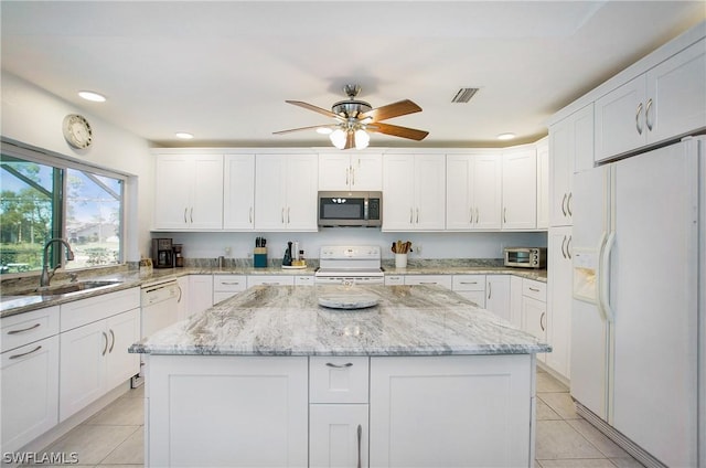 kitchen featuring white cabinetry, sink, white appliances, and a kitchen island