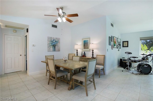 dining space featuring vaulted ceiling, light tile patterned floors, and ceiling fan