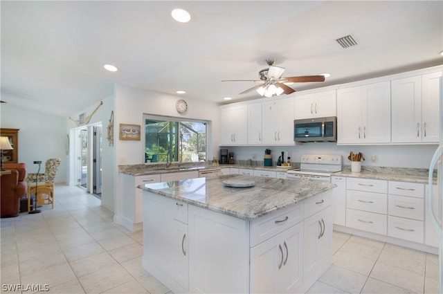 kitchen with white cabinets and electric range