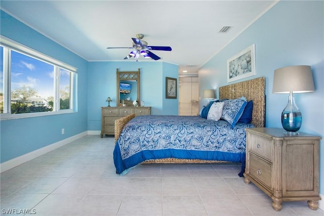 tiled bedroom featuring crown molding and ceiling fan