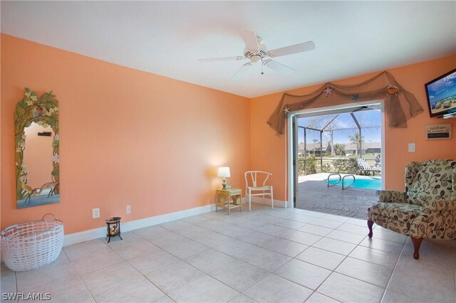 sitting room with light tile patterned floors and ceiling fan