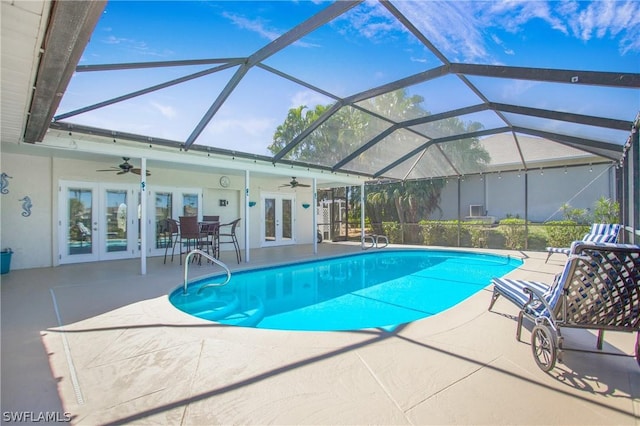 view of swimming pool with a patio area, ceiling fan, and french doors