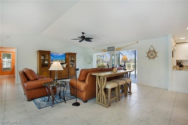 tiled living room featuring ceiling fan and lofted ceiling