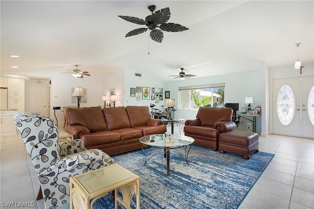 living room featuring lofted ceiling, french doors, ceiling fan, and light tile patterned flooring