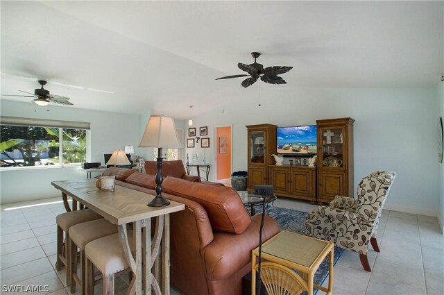 tiled living room featuring lofted ceiling and ceiling fan