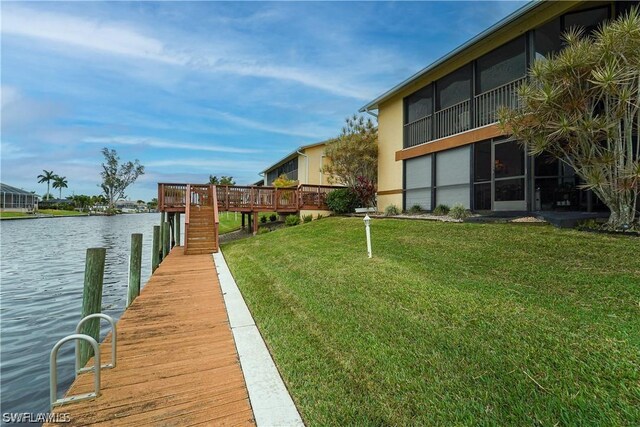 dock area with a yard and a water view