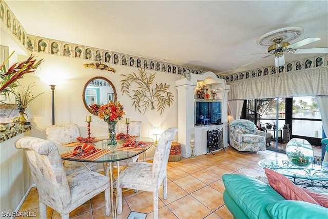 tiled dining room with ceiling fan