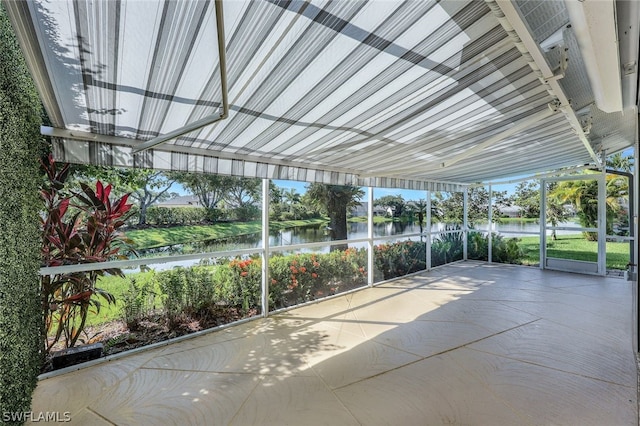 unfurnished sunroom with a water view